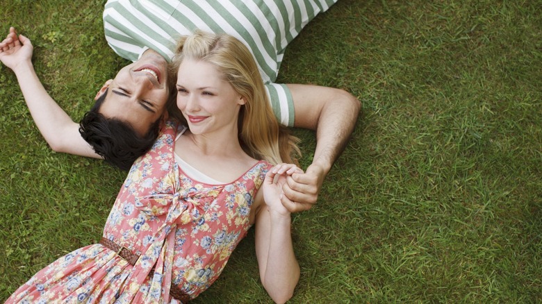 Couple lying in grass