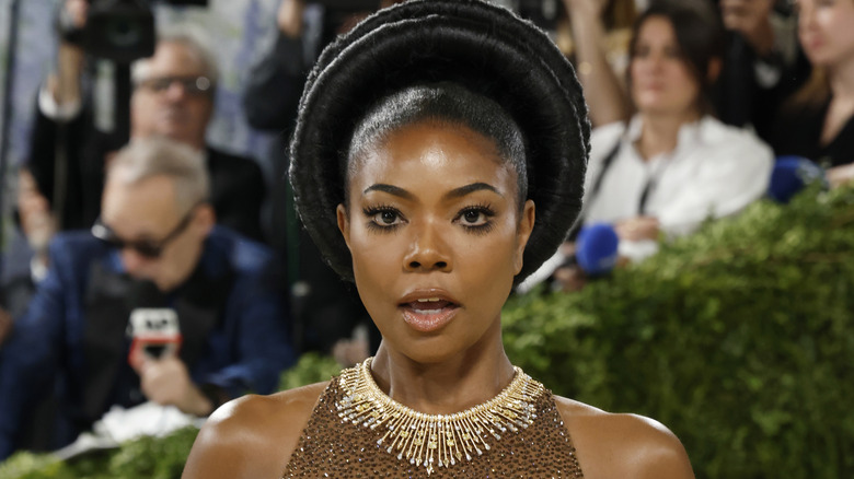 Gabrielle Union smiles in a brown sparkly dress