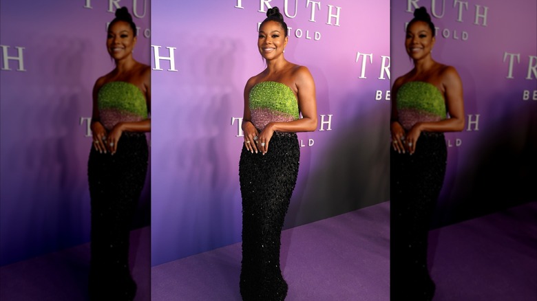 Gabrielle Union in a green, pink and black sleeveless dress