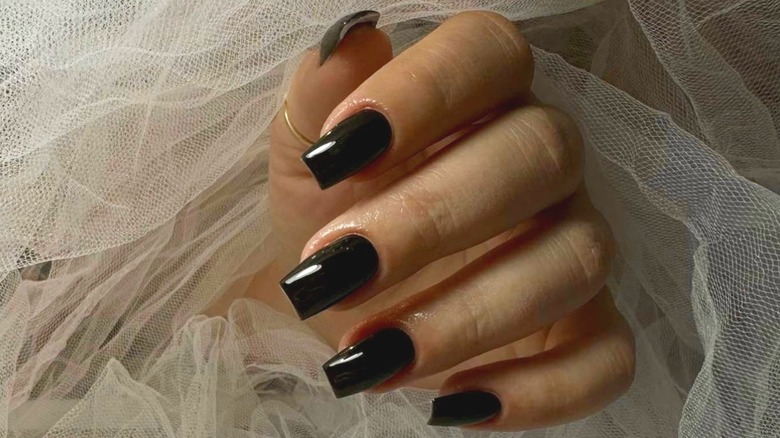 finger nail with black polish 