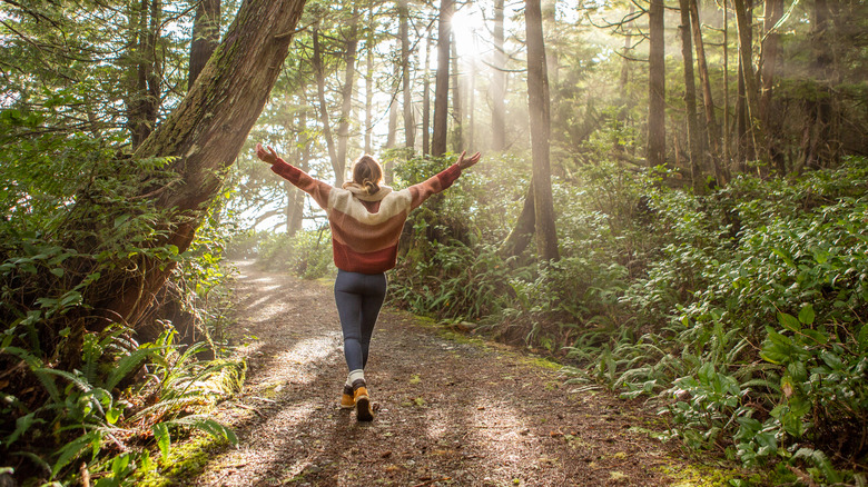 Woman happily walking trail