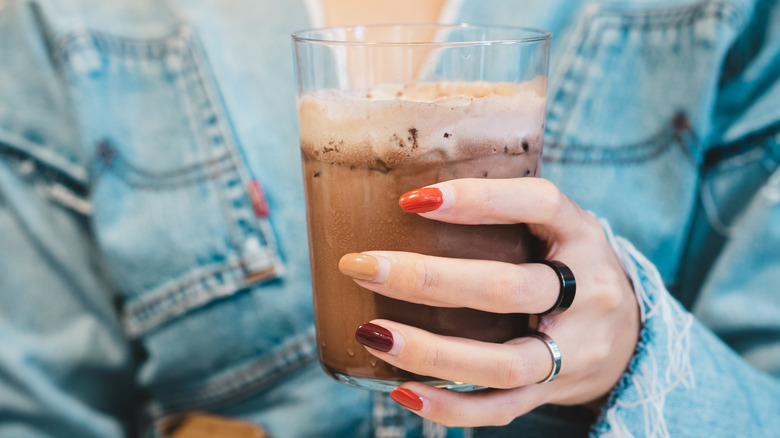 fingers with brown nail polish