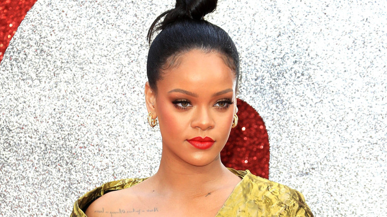 Rihanna posing in red lipstick