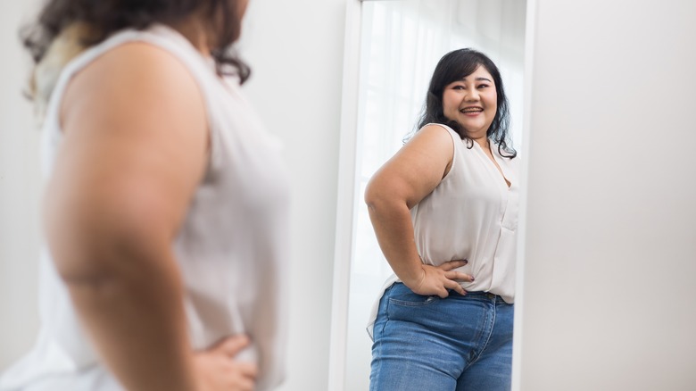 woman smiling trying on clothes