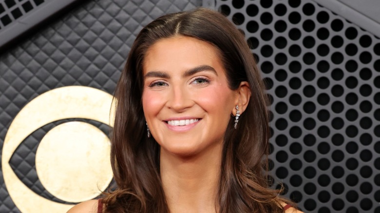 Close-up of Kaitlan Collins at a red carpet event. She is a fair-skinned woman with medium-length brown hair, slightly curled.