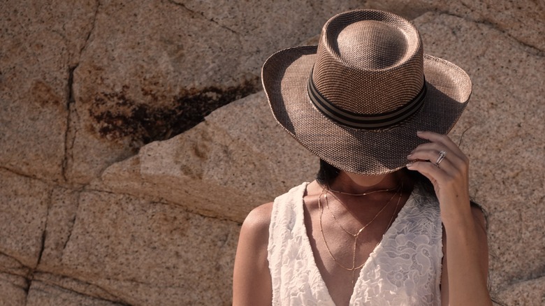 woman with cowboy hat and tank top