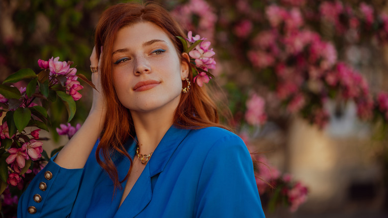 Woman poses wearing cobalt shirt 