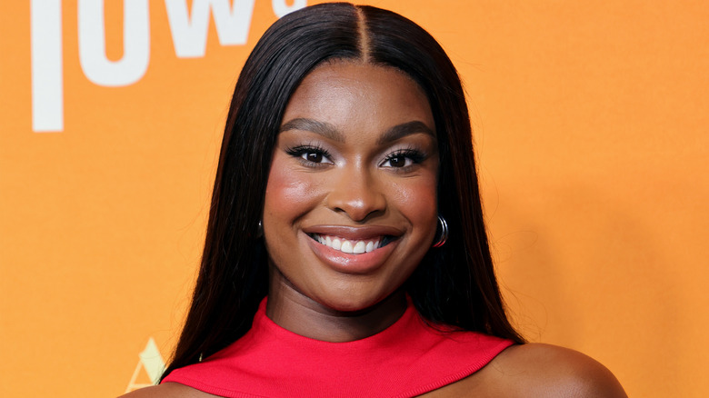 Coco Jones smiles on the red carpet