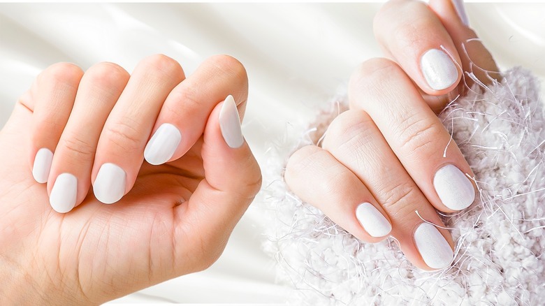 hands with coconut milk nails