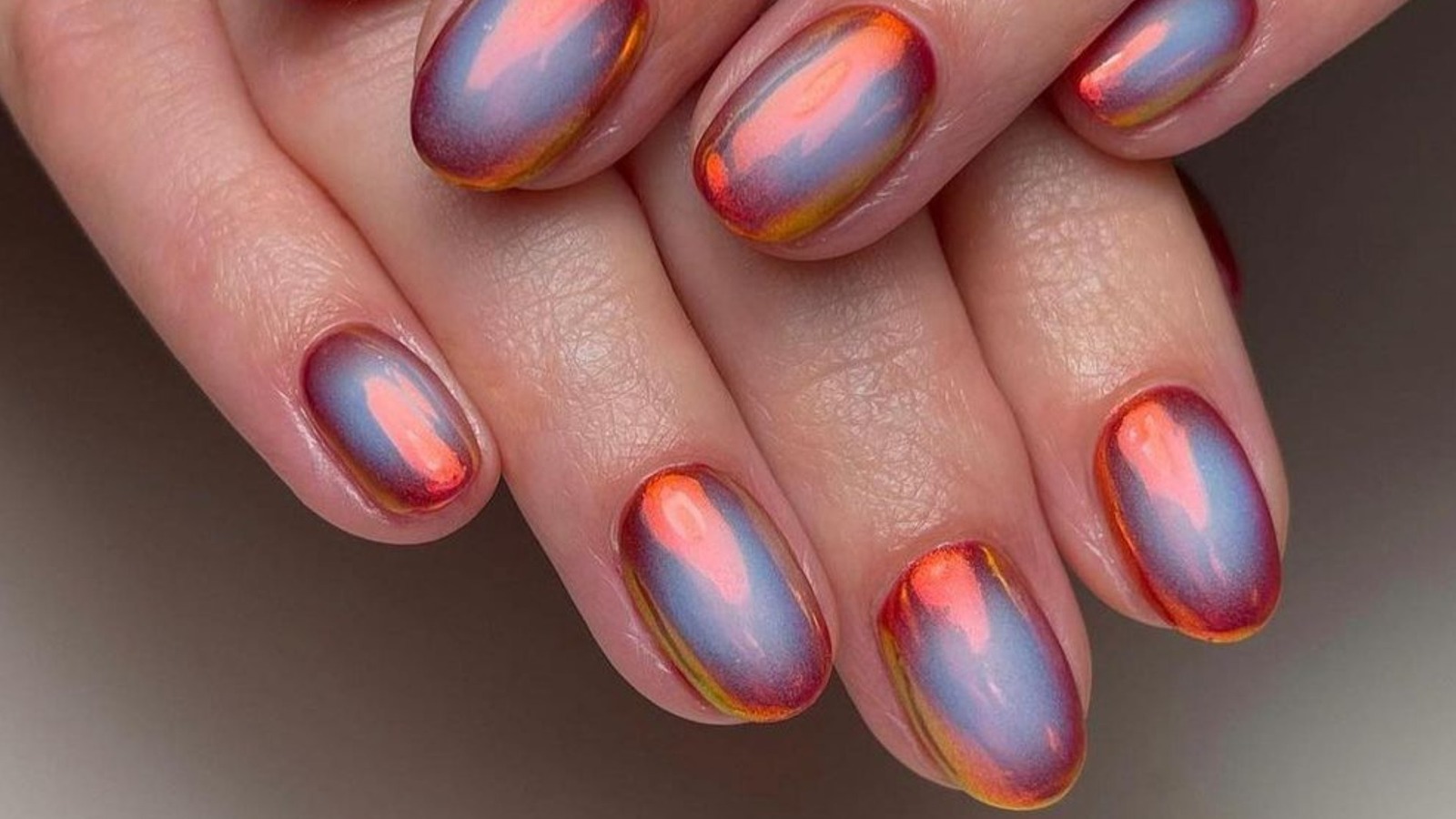 https://www.glam.com/img/gallery/color-shifting-chrome-nails-are-the-anti-minimalism-manicure-trend-of-2023/l-intro-1690741745.jpg?utm_source=chatgpt.com