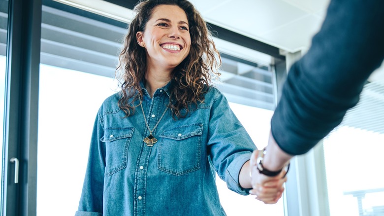 Woman wearing denim shirt at business meeting