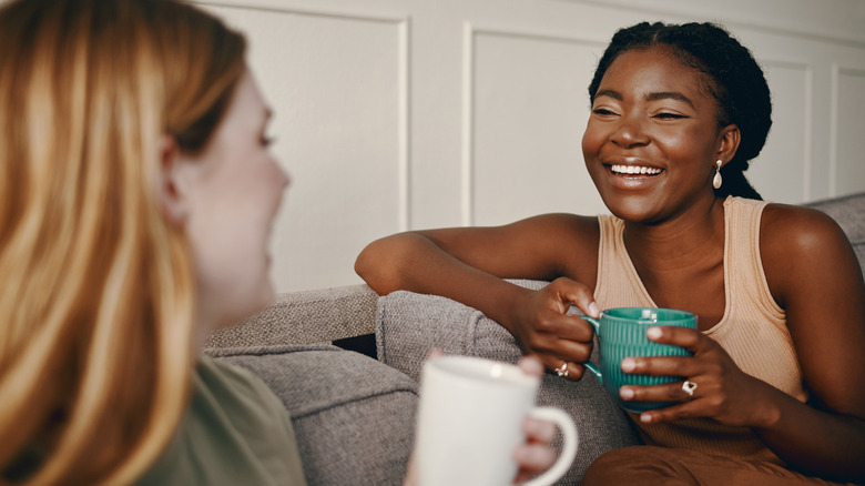 Friends laughing, drinking coffee