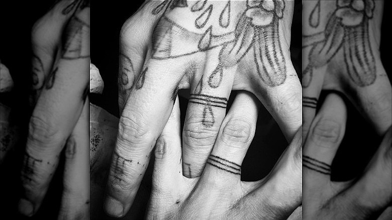 couple wearing triple wedding band tattoo