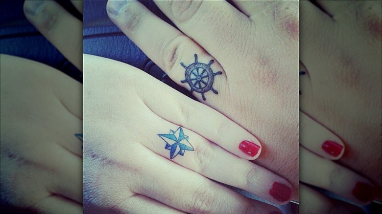 couple wearing ring finger tattoos