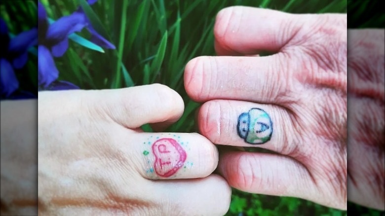 couple with colorful wedding ring tattoos