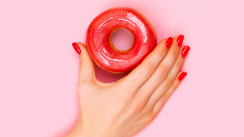 Woman with long coral glazed nails