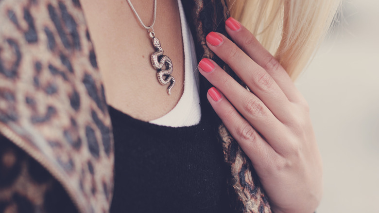 Woman with coral manicure