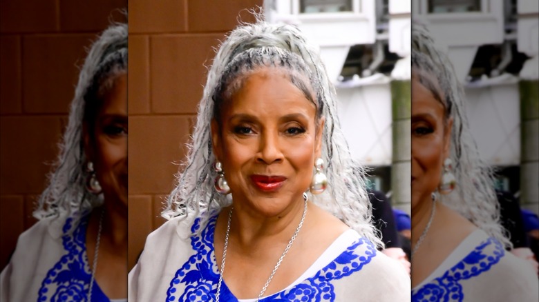 Phylicia Rashad wearing a blue-and-white tunic and her hair in braids