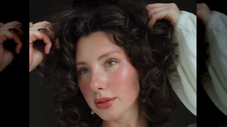 A person with romantic cottagecore makeup and curly hair