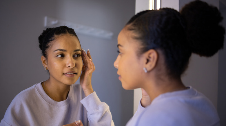 woman looking in mirror