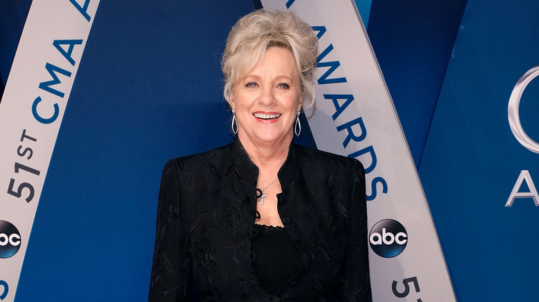Connie Smith pictured in 2017 with her hair in an updo wearing a black blazer.