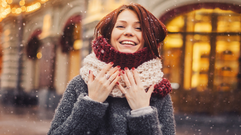 Smiling woman during snowfall