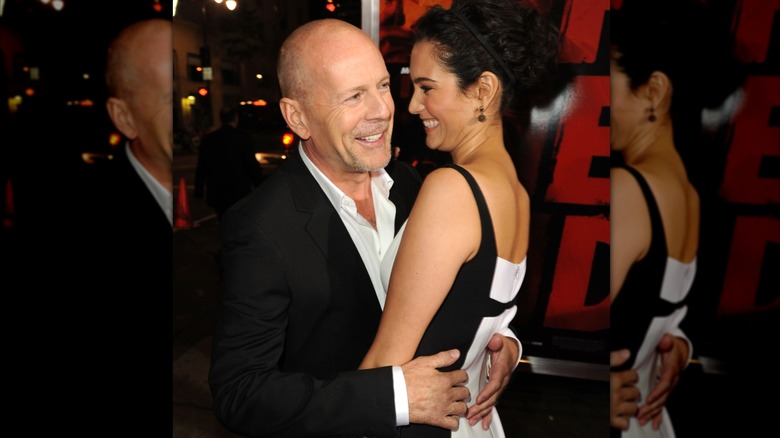 Bruce Willis and wife Emma Heming Willis are seen laughing and hugging while on the red carpet together