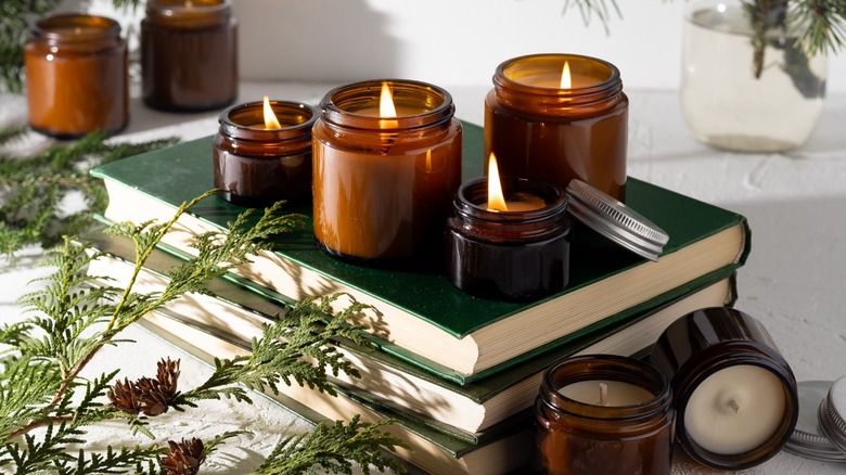 Lit candles on books