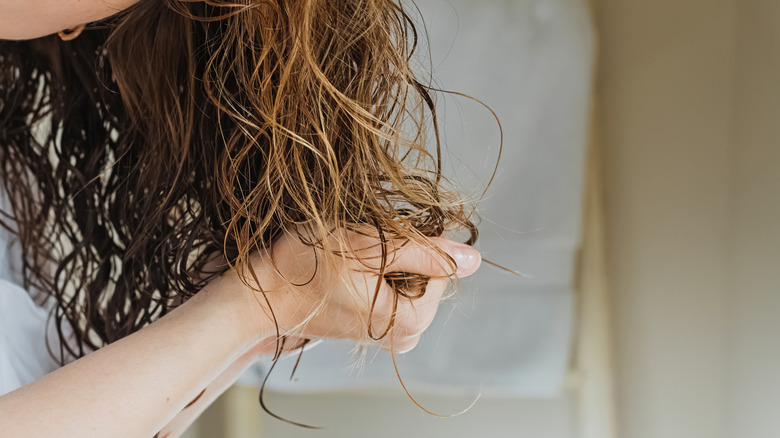 Woman scrunching curly hair