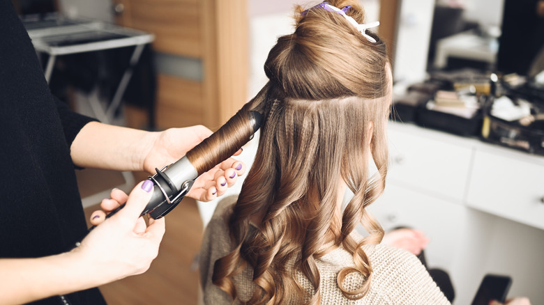 Woman having her hair curled