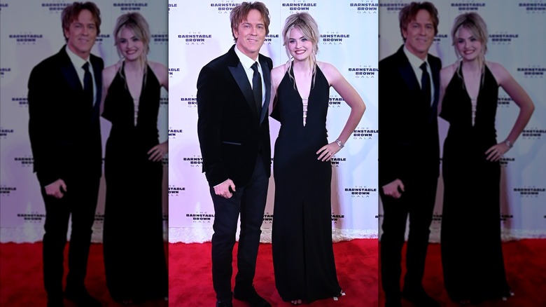 Larry Birkhead stands next to Dannielynn Birkhead who wears a black dress