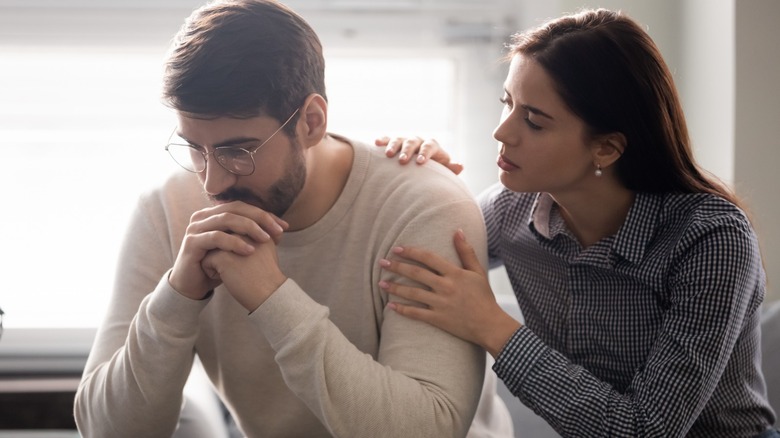 Woman hugging sad man