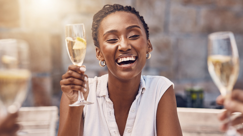 a woman drinks champagne