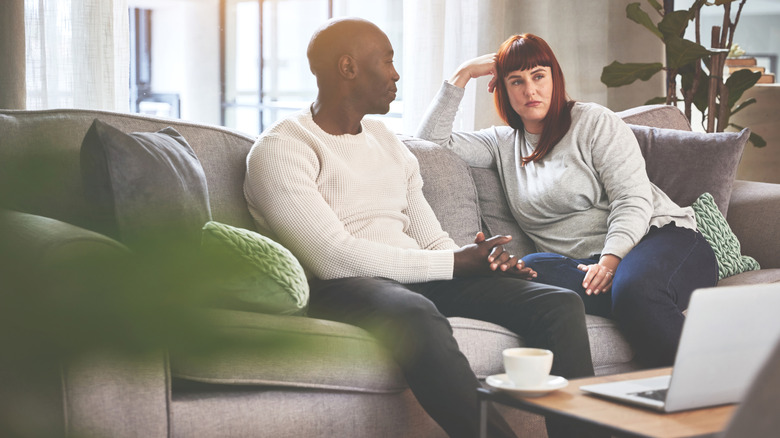 Couple having discussion on sofa