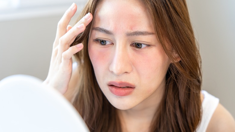 Concerned woman looking at skin