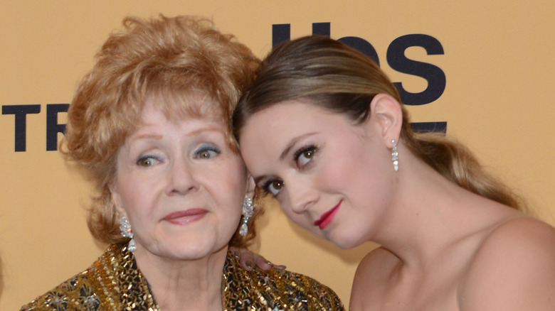 Debbie Reynolds and Billie Lourd posing together with glam makeup at an event.