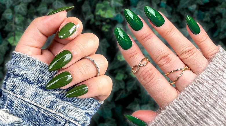 Two women wearing evergreen nails
