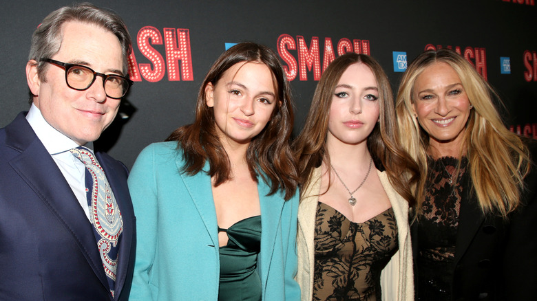 Matthew Broderick and Sarah Jessica Parker pictured smiling at a red carpet event with daughters Tabitha and Marion.