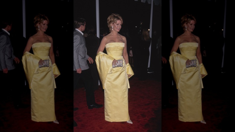 Deidre Hall smiles wearing a strapless butter-yellow gown and shawl