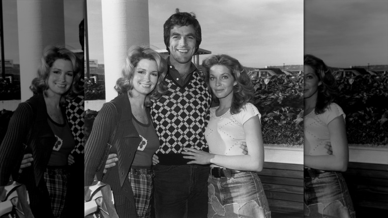 Deidre Hall (left) smiles wearing a cardigan next to Tom Selleck (middle) and Jaime Lyn Bauer (right)