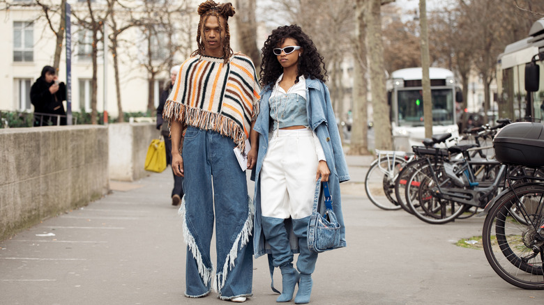 Couple posing in denim outfits