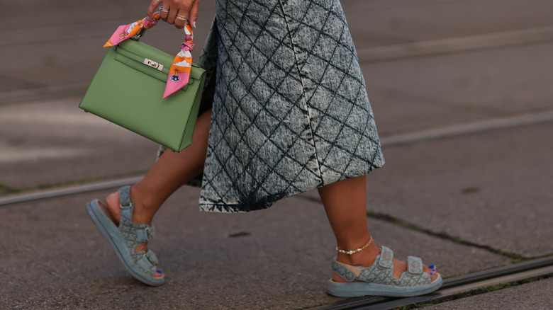 woman wearing denim midi skirt and sandals