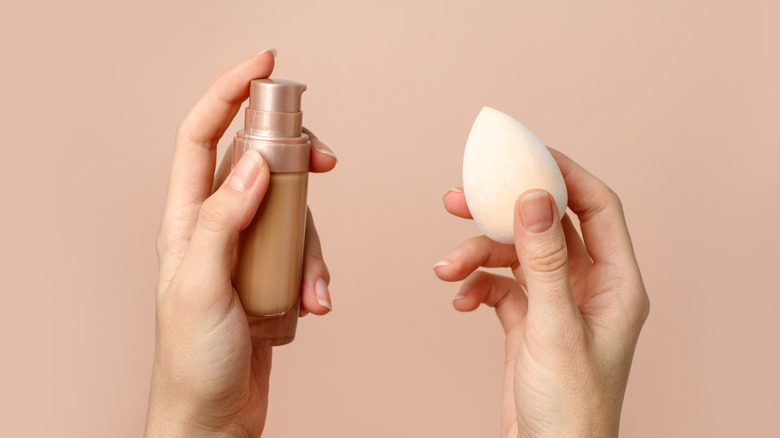 Woman holding foundation beauty sponge