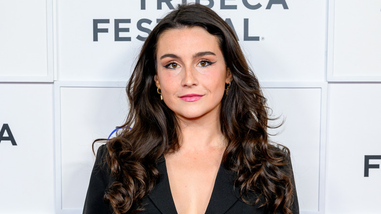 Olivia DeLaurentis at an event wearing a black blazer with long, softly-curled hair.