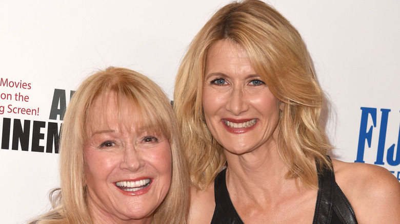 Diane Ladd and Laura Dern have matching blond hair while they give giant smiles to the cameras at a fancy red carpet event