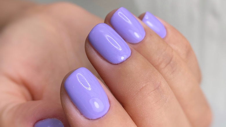 hand with lavender gel nails 