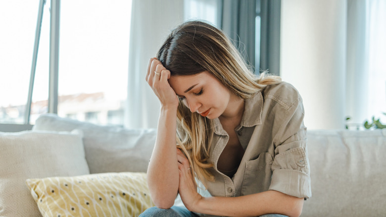 Overwhelmed woman on couch