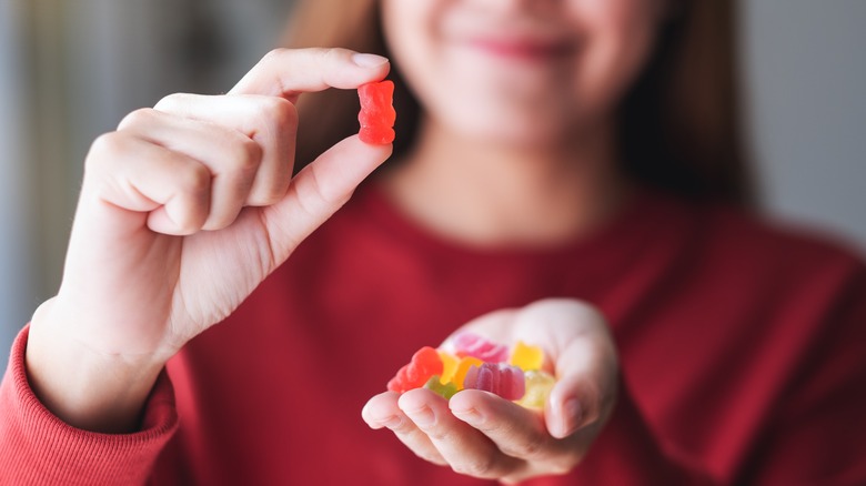 Woman holding gummy bears