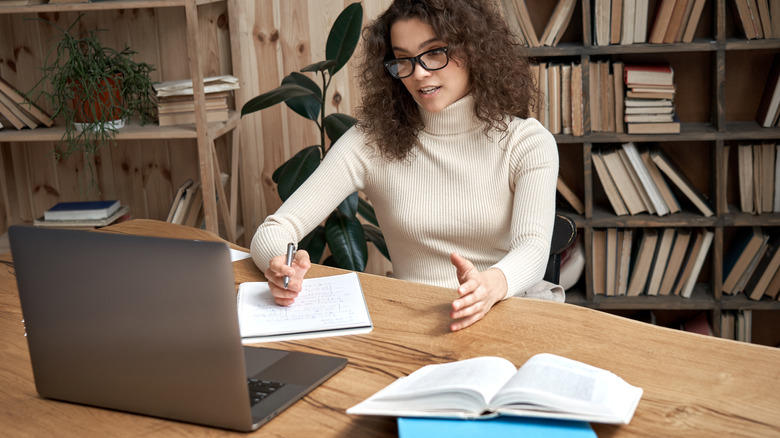 woman wearing glasses using computer 