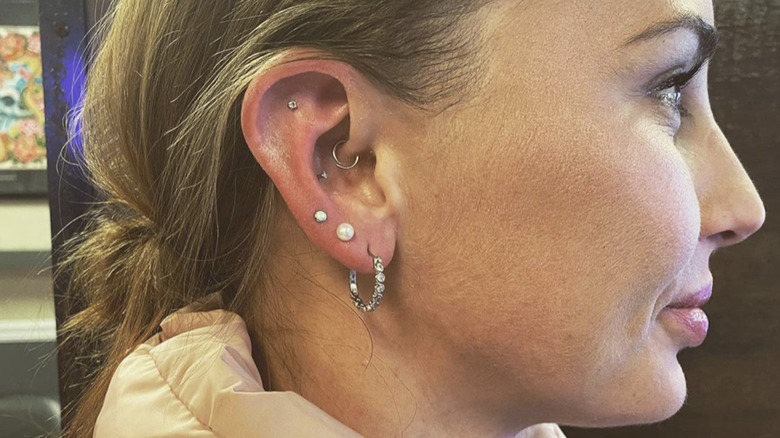 Model with daith piercing visible